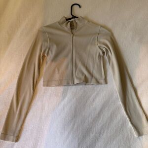 Garage 
Zip up long sleeve , ribbed and stretchy